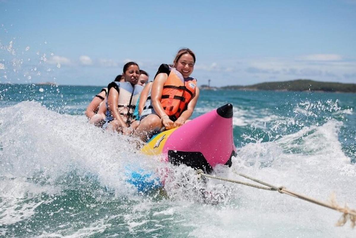 three people riding on a jet ski in the water