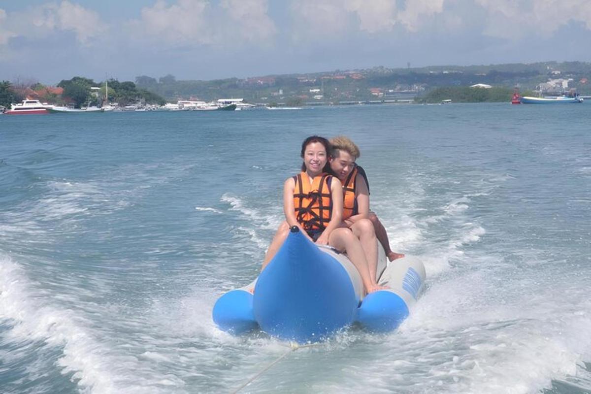 two girls riding on a raft in the water