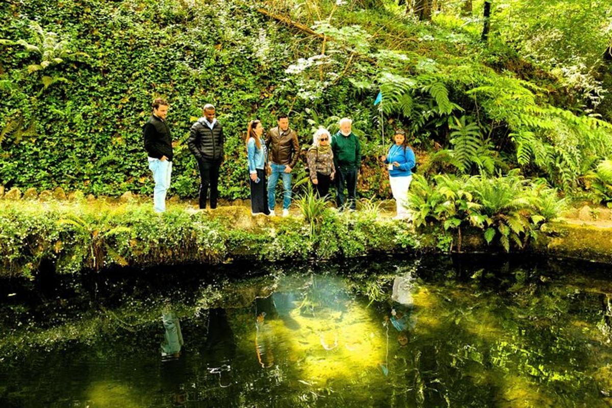 a group of people standing next to a body of water