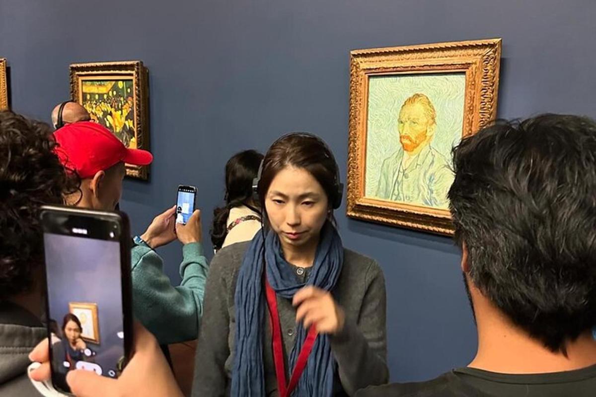 a person taking a picture of a woman at a painting