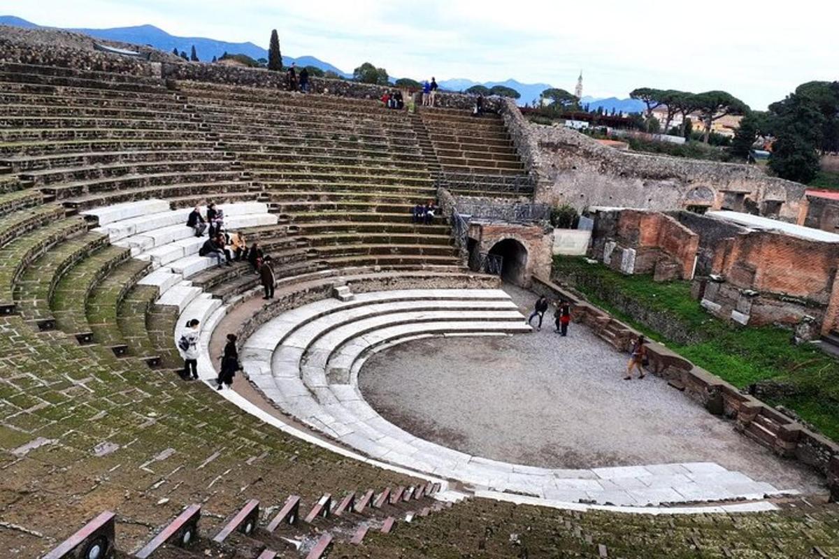 an amphitheater with people standing in the stands