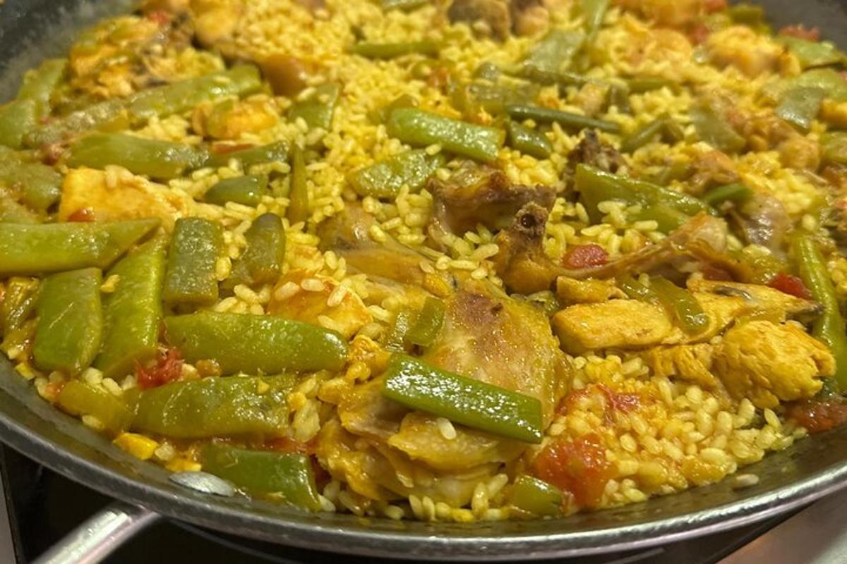 a pan of food with green beans and rice