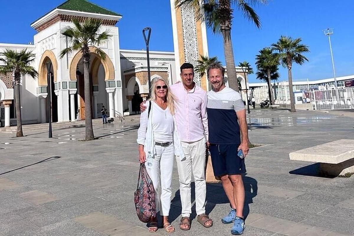 a group of three people standing in front of a building