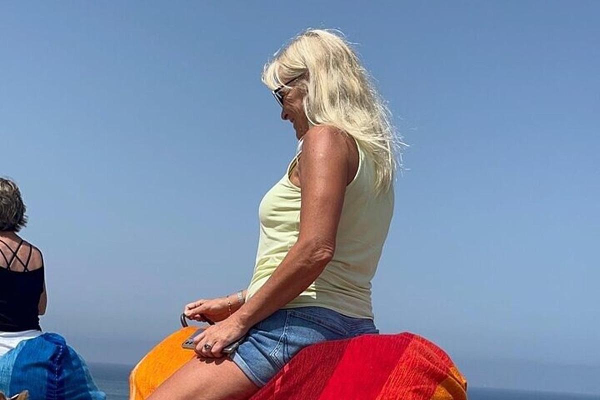 a woman sitting on top of a surfboard