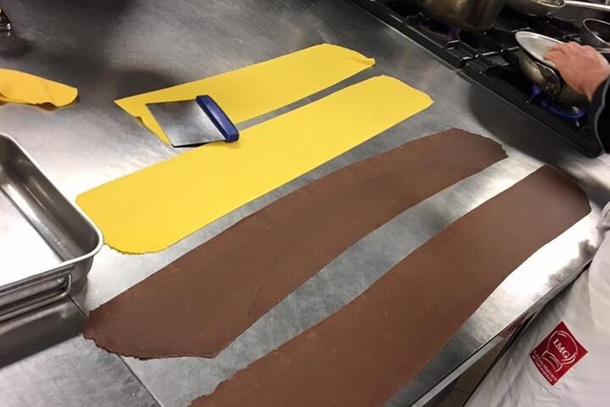 a metal counter with a knife and a yellow folder