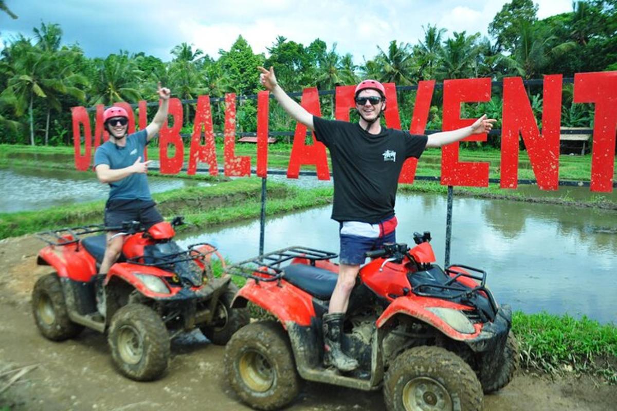 two men on atvs in front of a sign