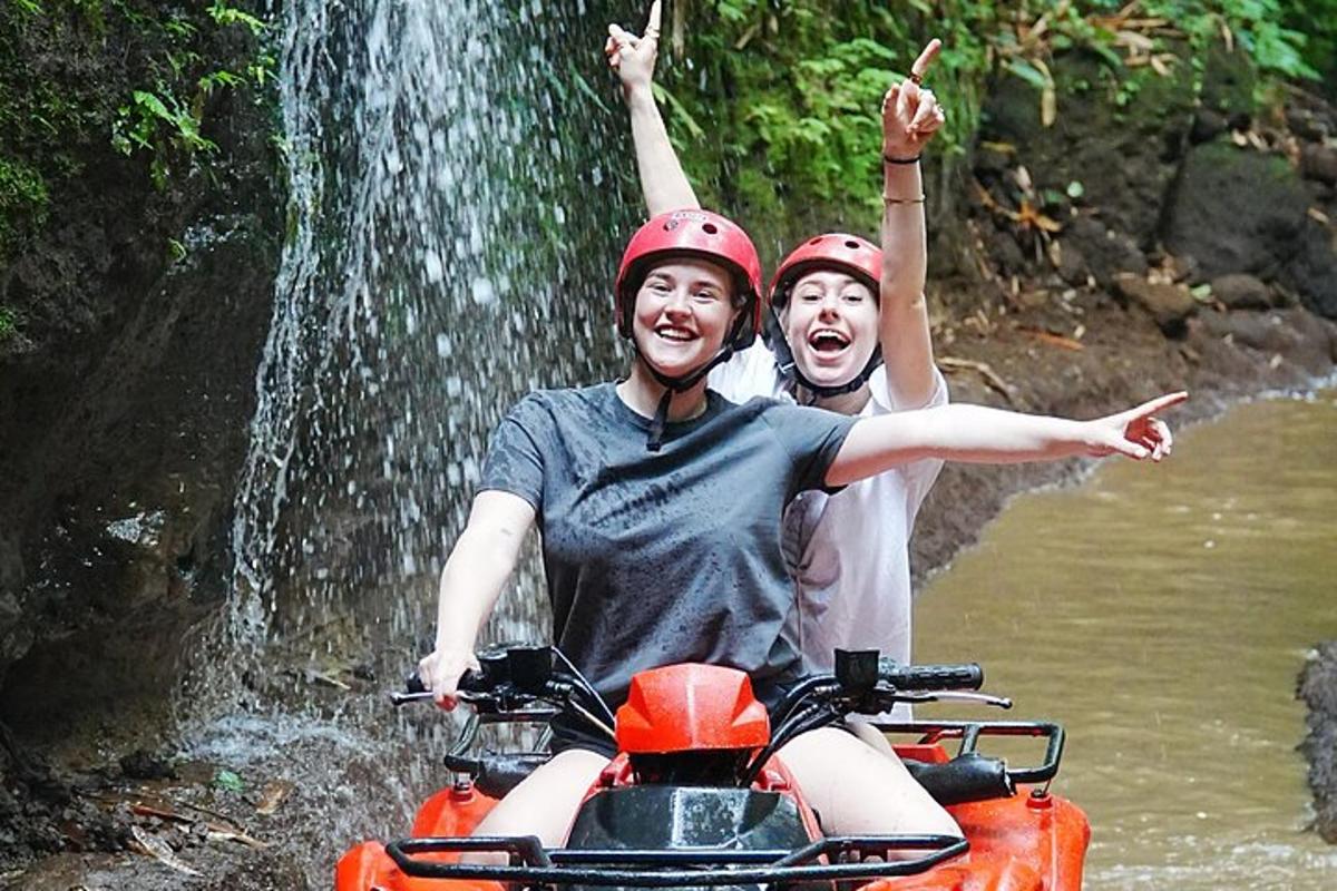two people on a motorcycle in front of a waterfall