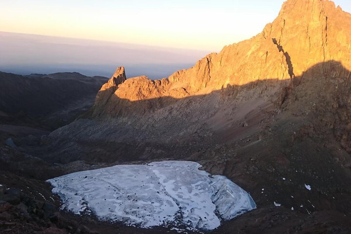 a mountain with a chunk of snow on it