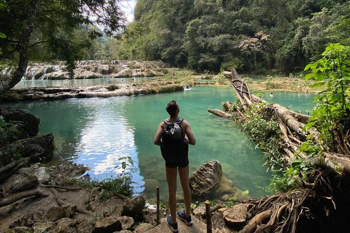 a woman standing on a path next to a river