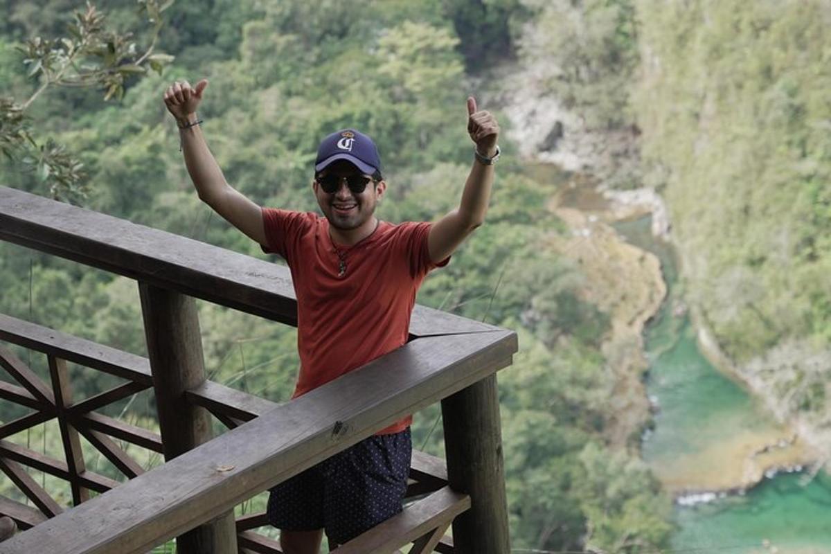 a man standing on a fence with his hands in the air