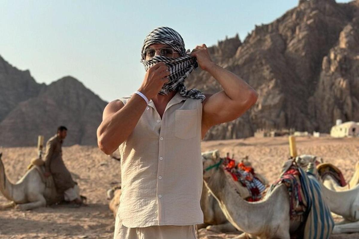 a man with a mask on his face in the desert
