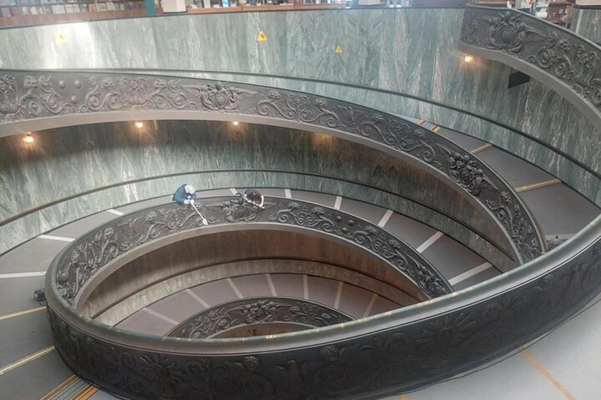 a spiral staircase in a building with people on it