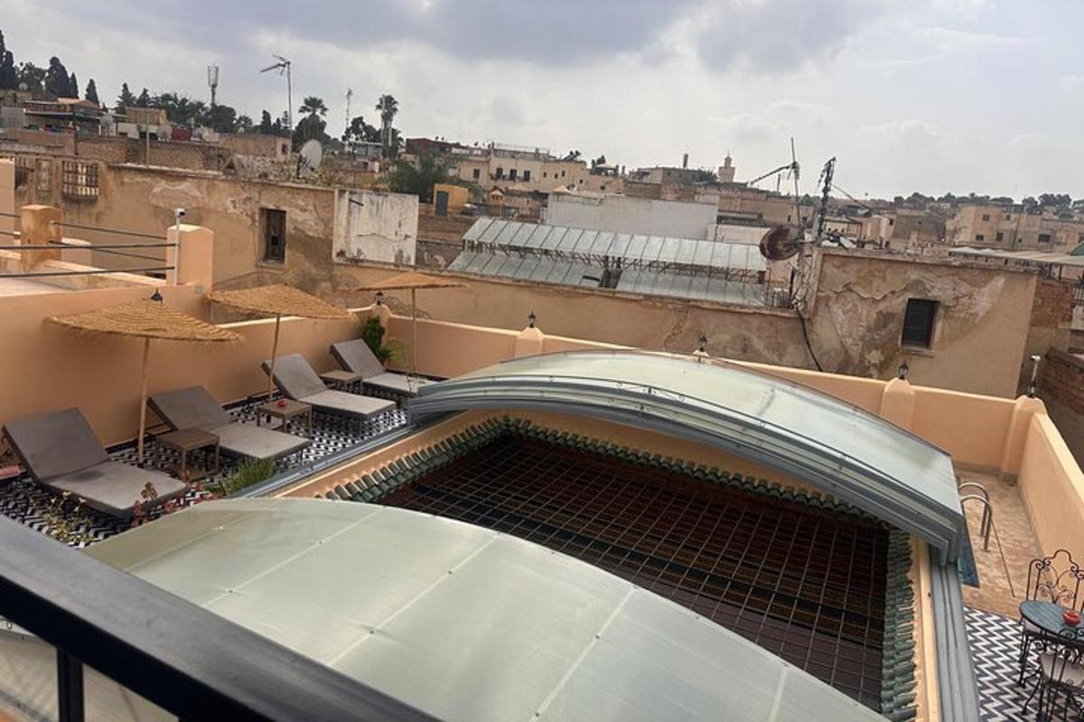a view of a balcony with chairs and a building