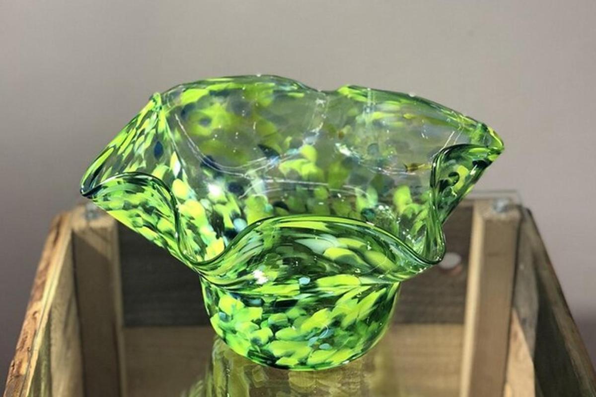 um vaso de vidro verde em cima de uma mesa