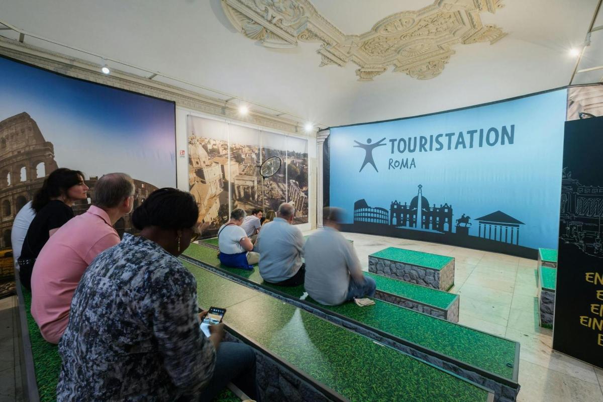 a group of people sitting on a bench in a museum