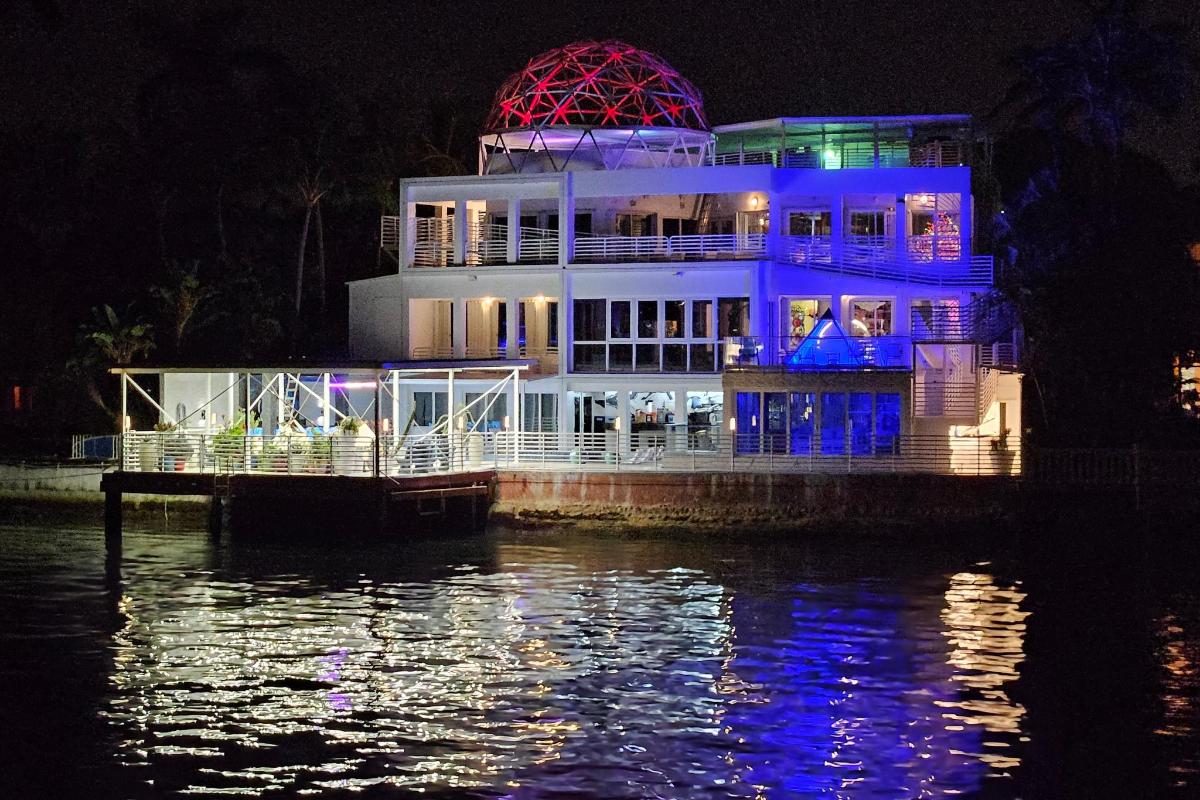 a large building on the water at night