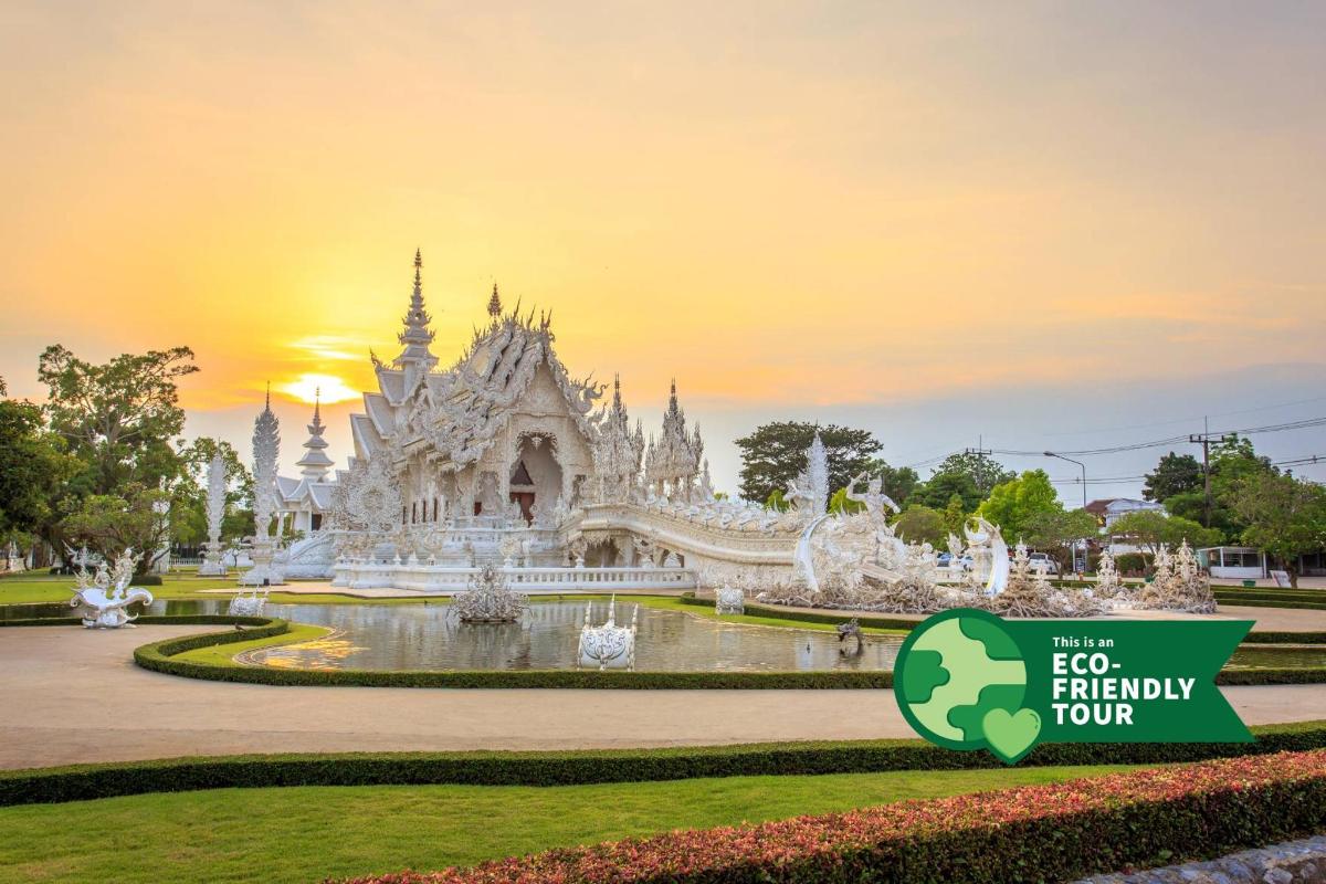 a white temple with a sign in front of it