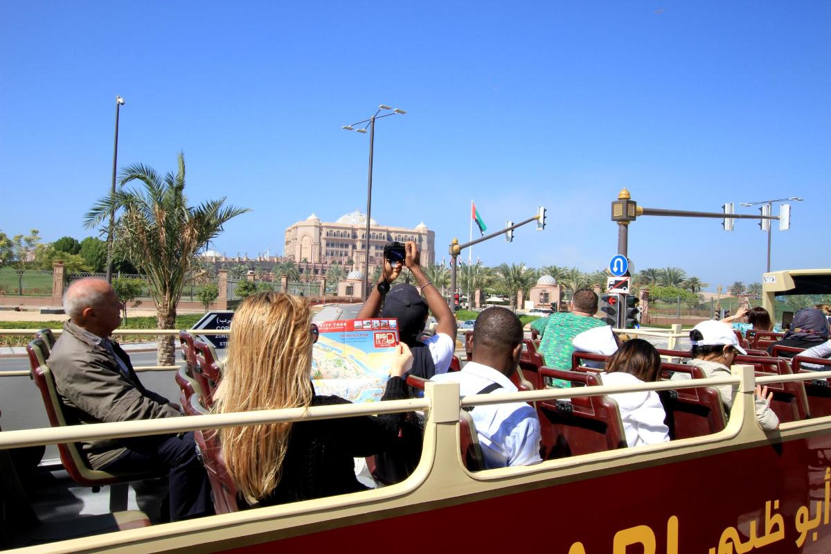 a group of people riding on a double decker bus