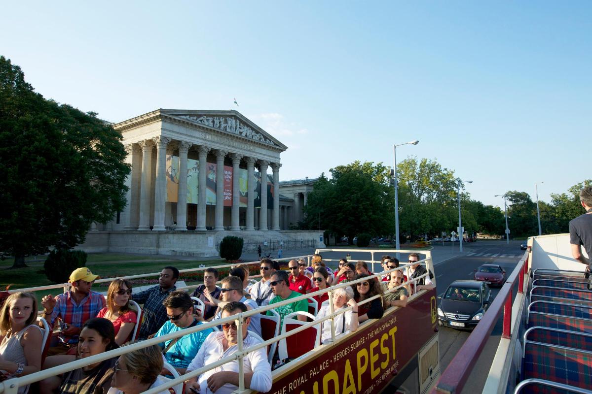 a group of people riding on a double decker bus