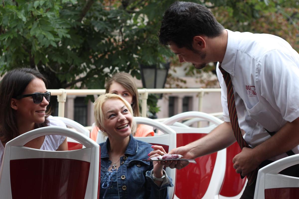a man is handing a woman a piece of cake