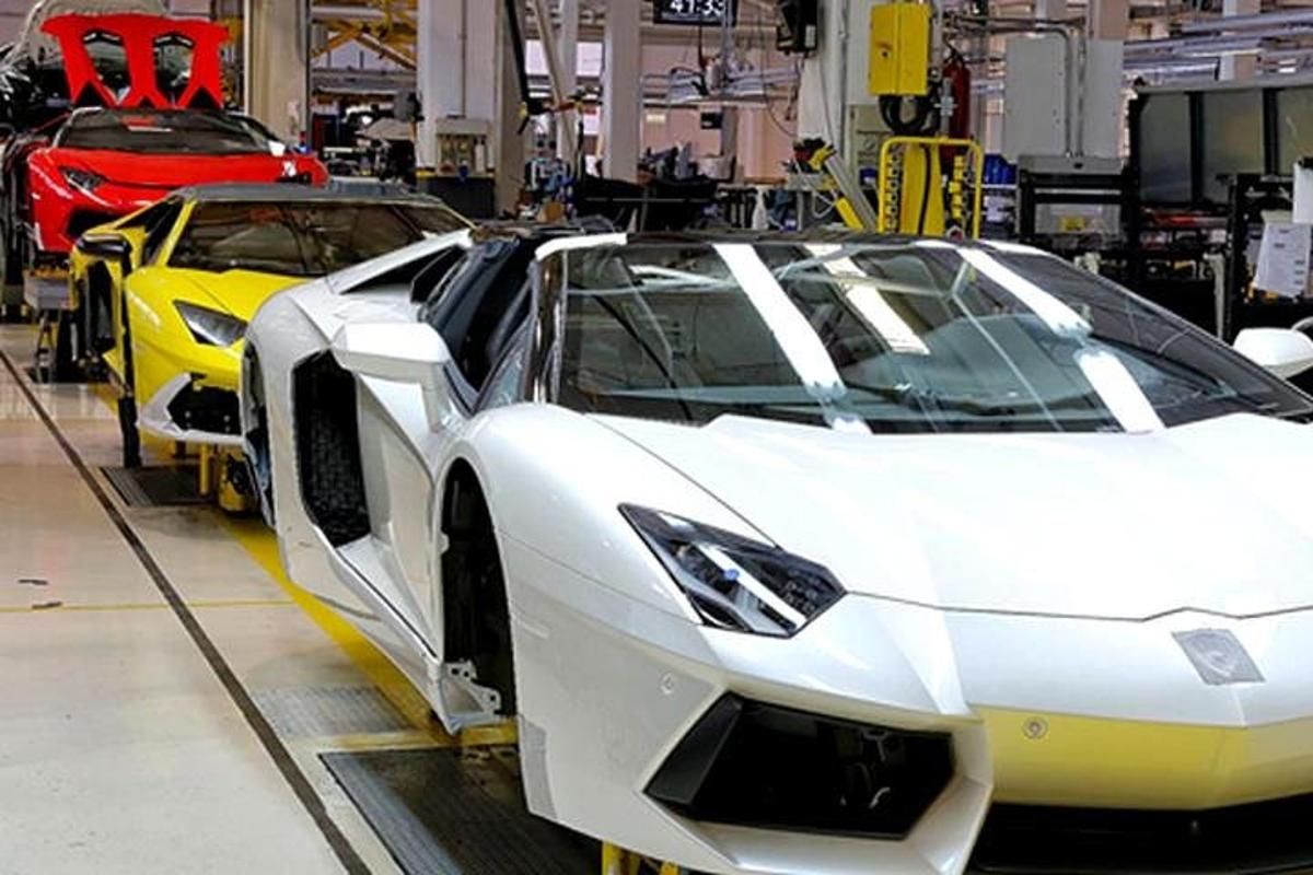 um carro branco em uma linha de montagem com outros carros