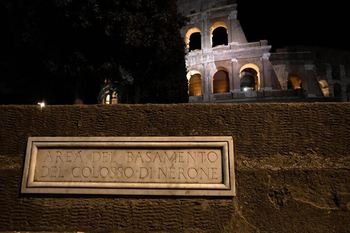 a sign on a wall with a building in the background