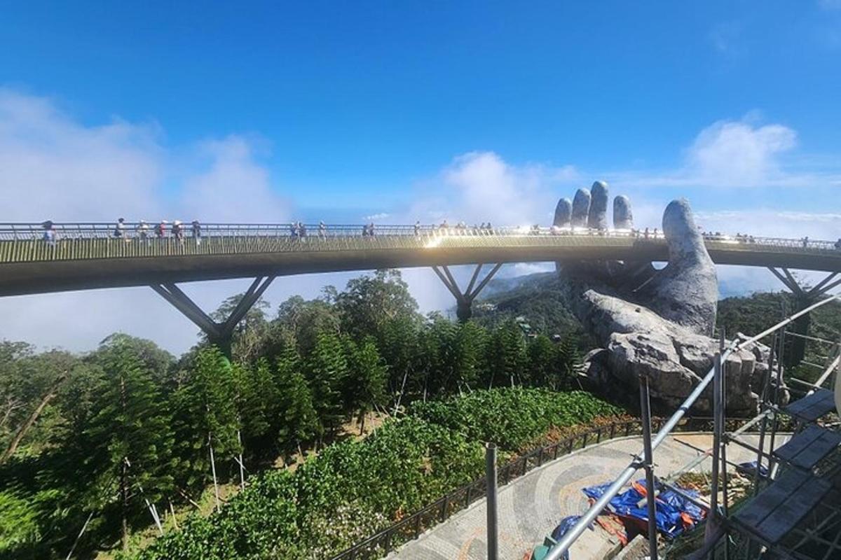 a bridge over a mountain with people walking on it