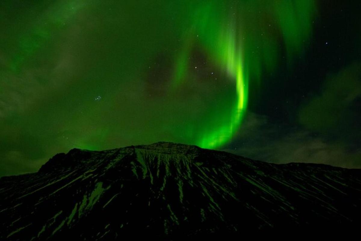 un'immagine dell'aurora che danza su una montagna