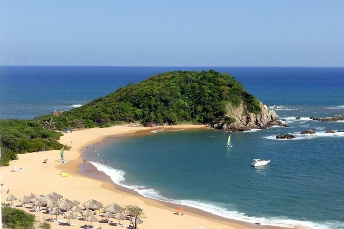 a beach with people and a boat in the water
