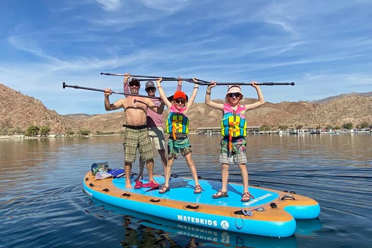 a group of people on a paddle board on the water