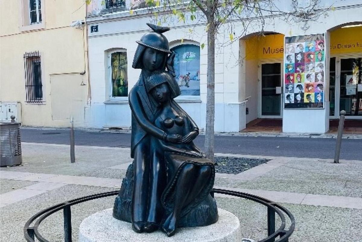 una statua di una donna in piedi su una strada