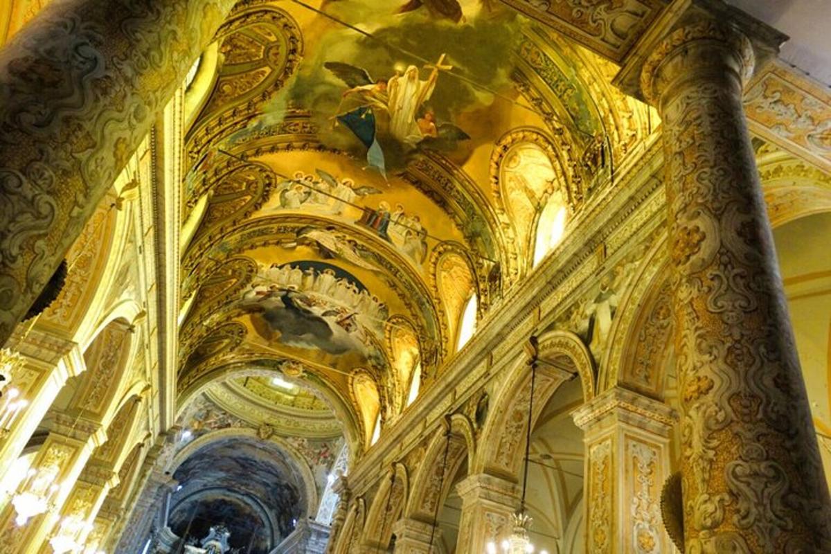 a church with ornate ceilings and a painting on the ceiling