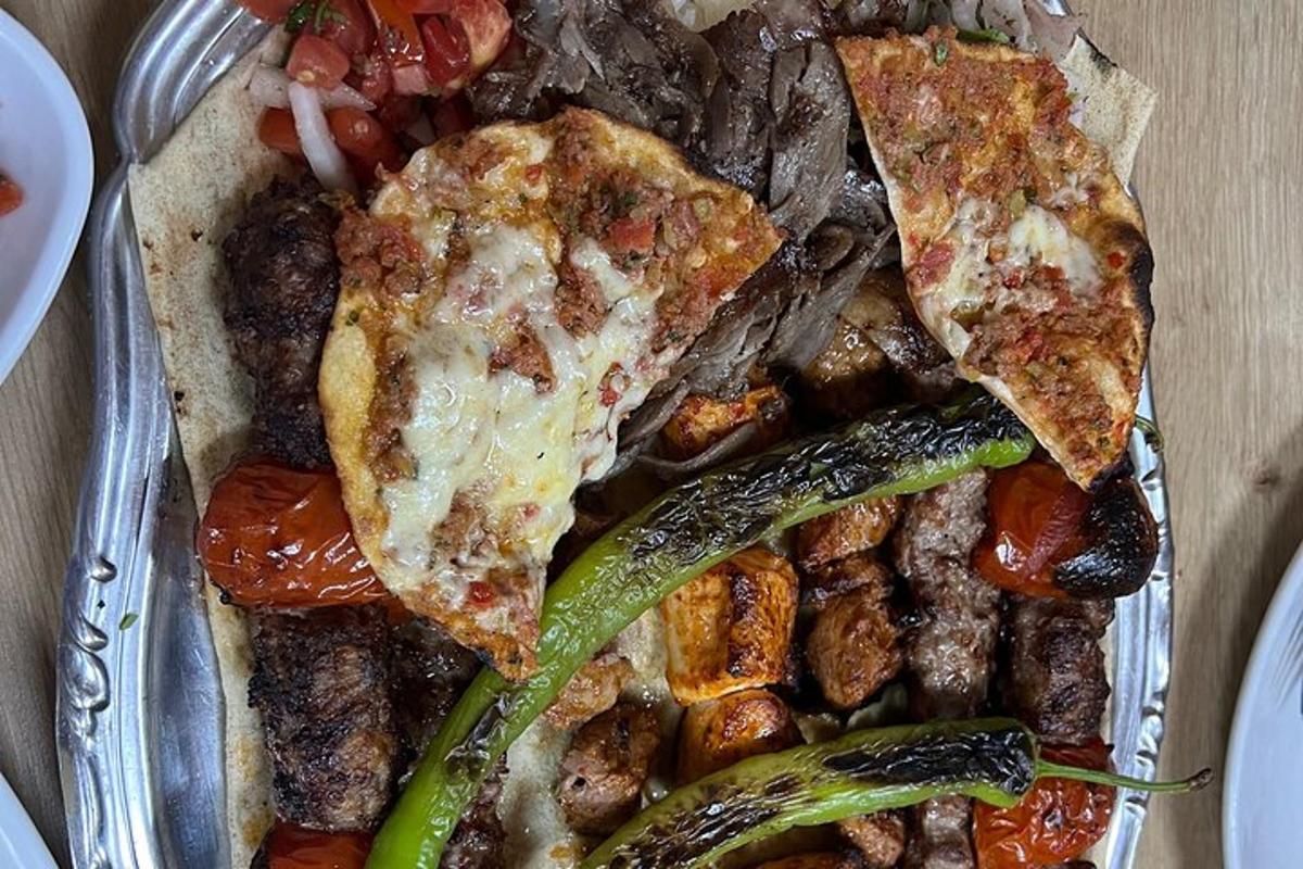 o tavă cu mâncare, pizza și legume pe o masă