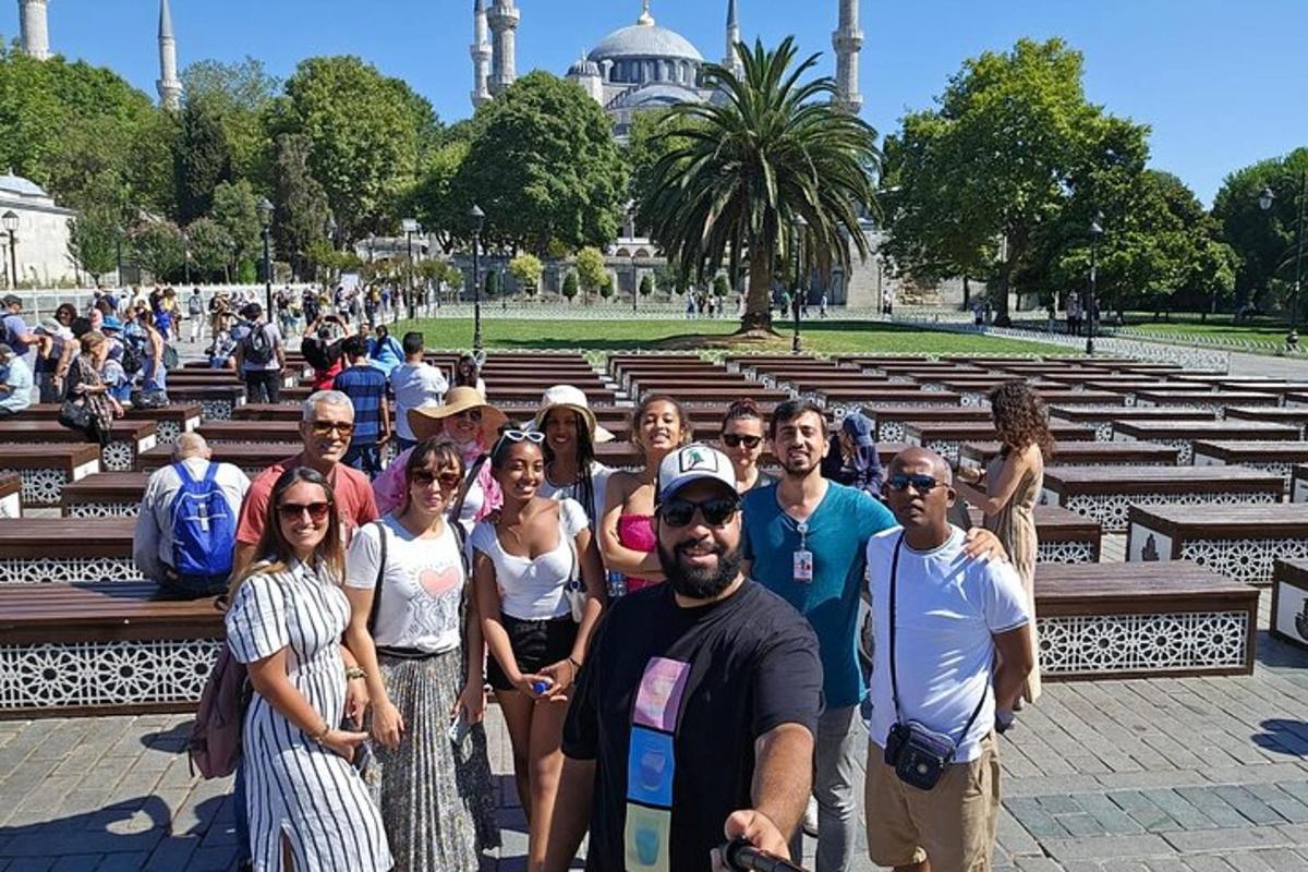 a group of people posing for a picture in front of a mosque