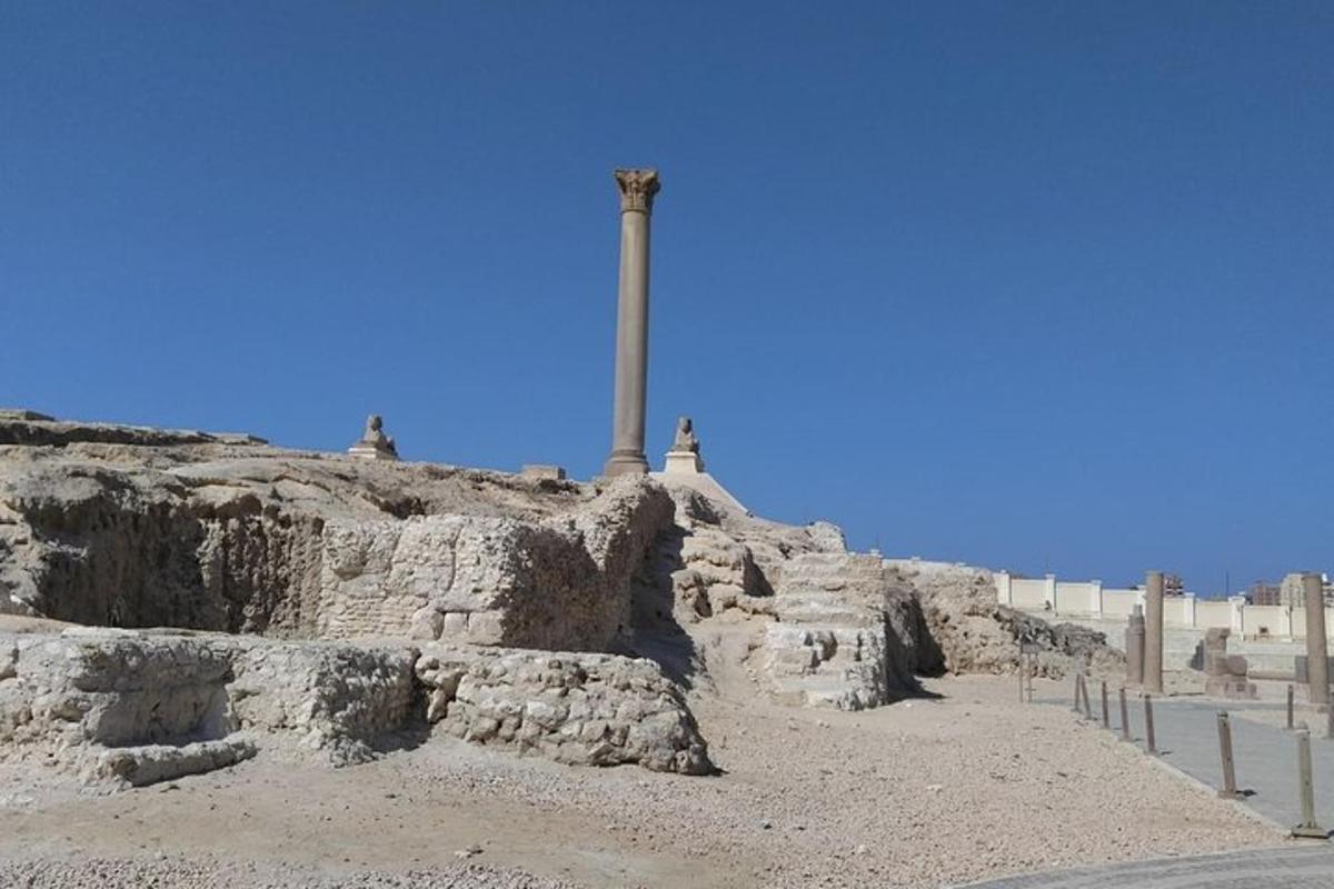 a cross on top of a hill with a monument