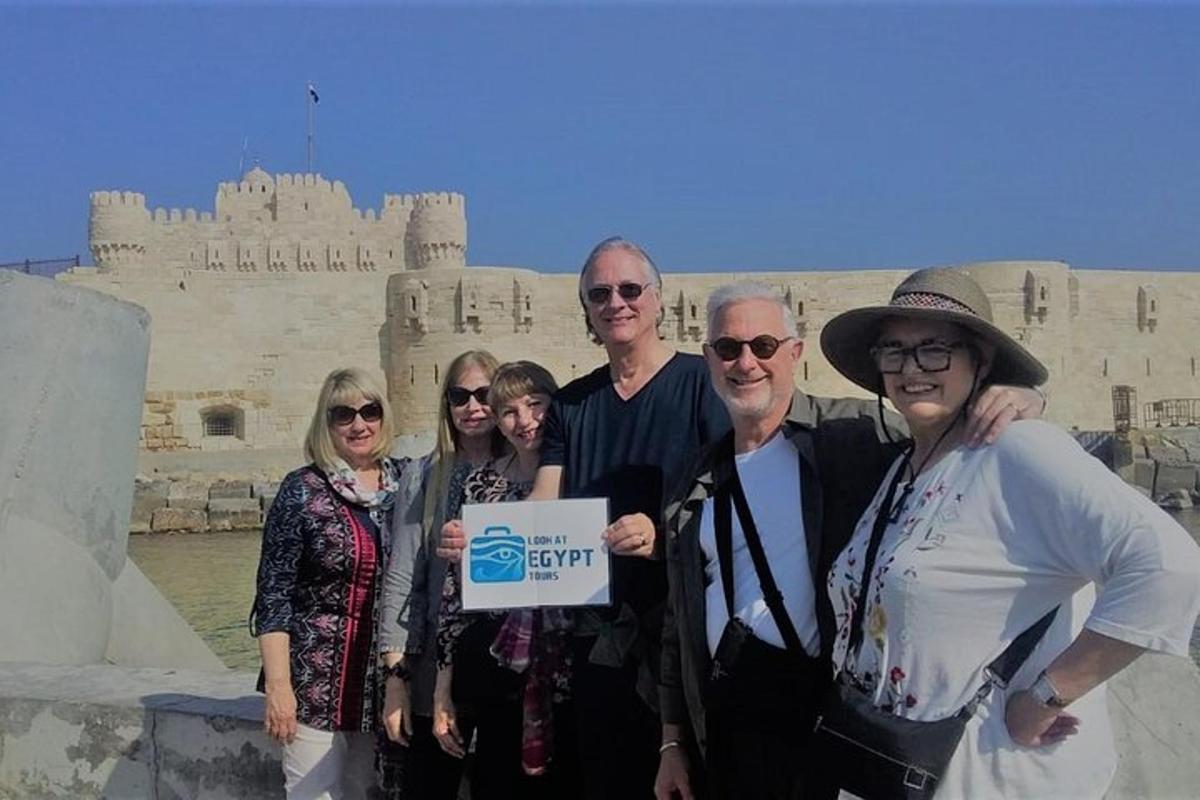 a group of people posing for a picture in front of a castle