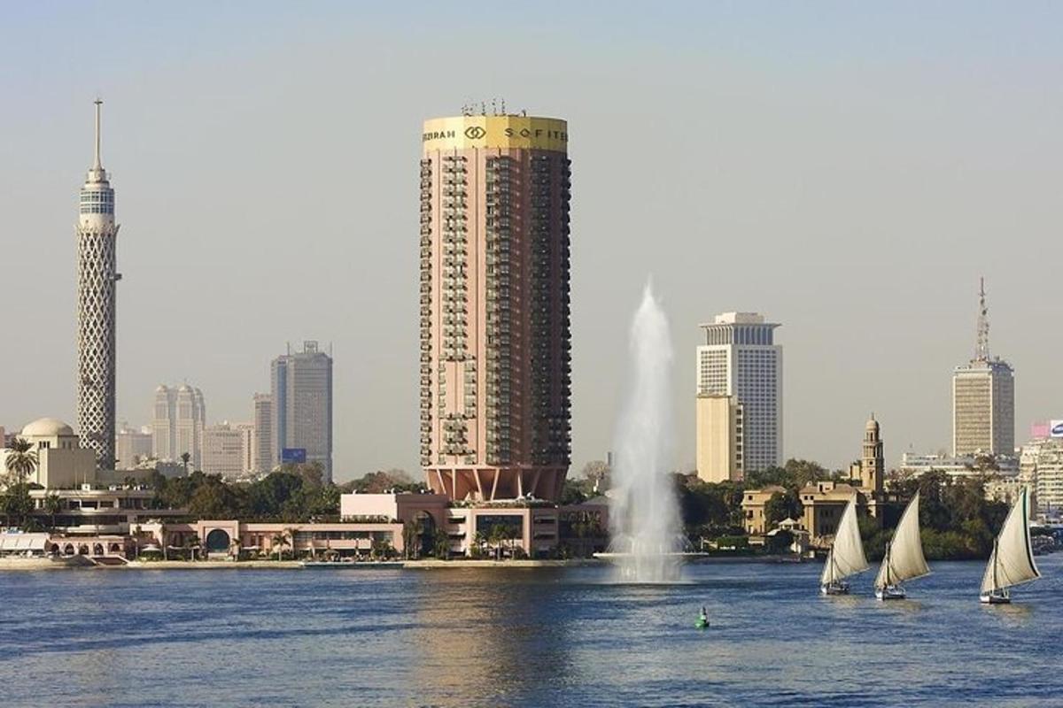 a group of sailboats in the water in front of a city