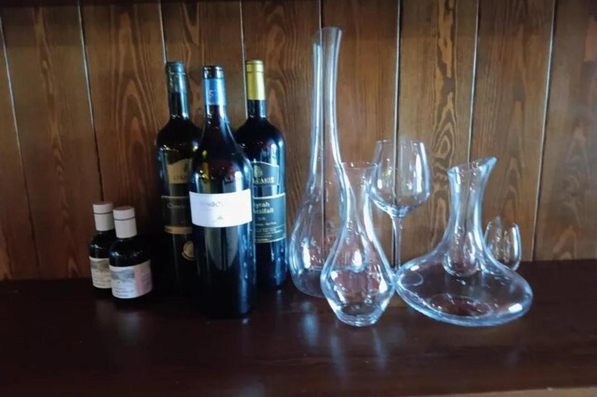 a group of wine bottles and wine glasses on a table