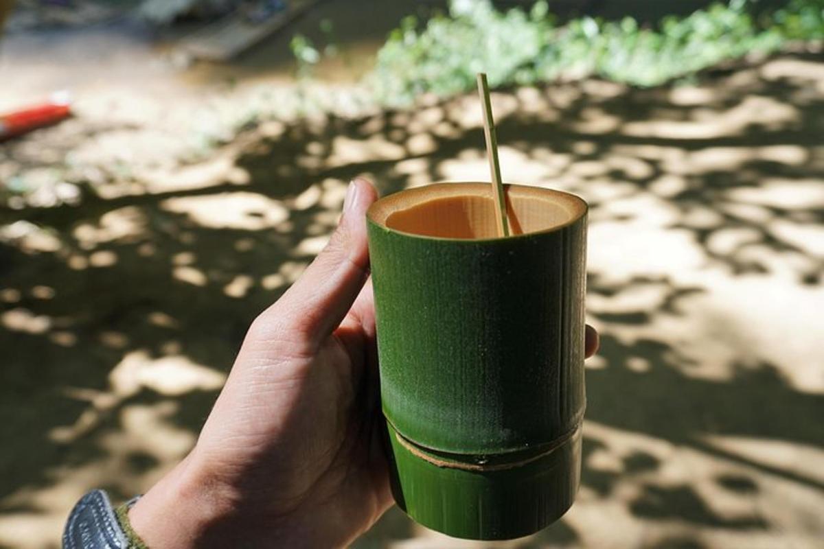 a person holding a green cup with a straw