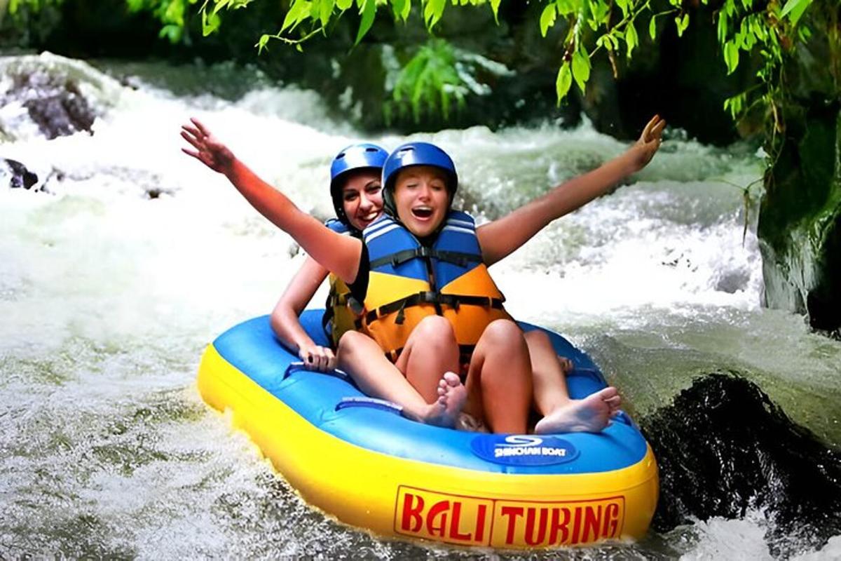 two girls are riding on a raft on a river