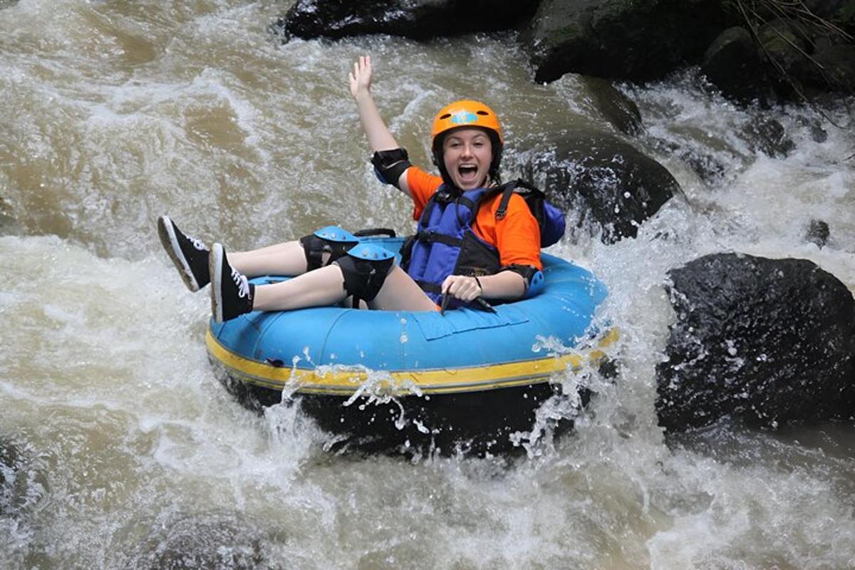 a young girl is riding on a raft in the water