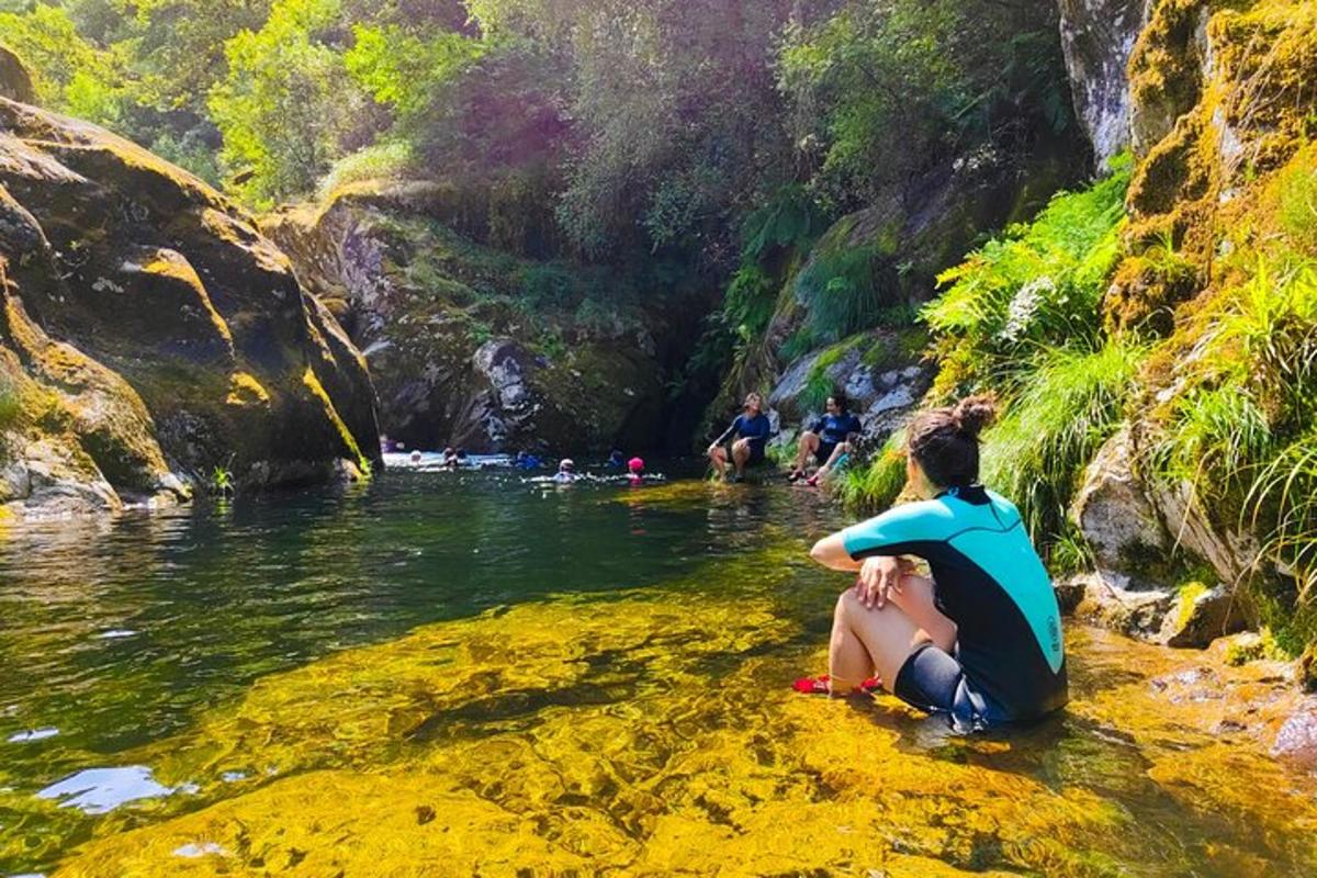 a group of people sitting in the water in a river