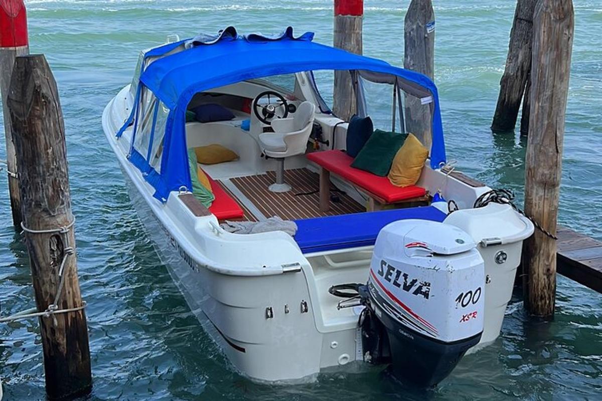 a small boat tied up to a dock in the water