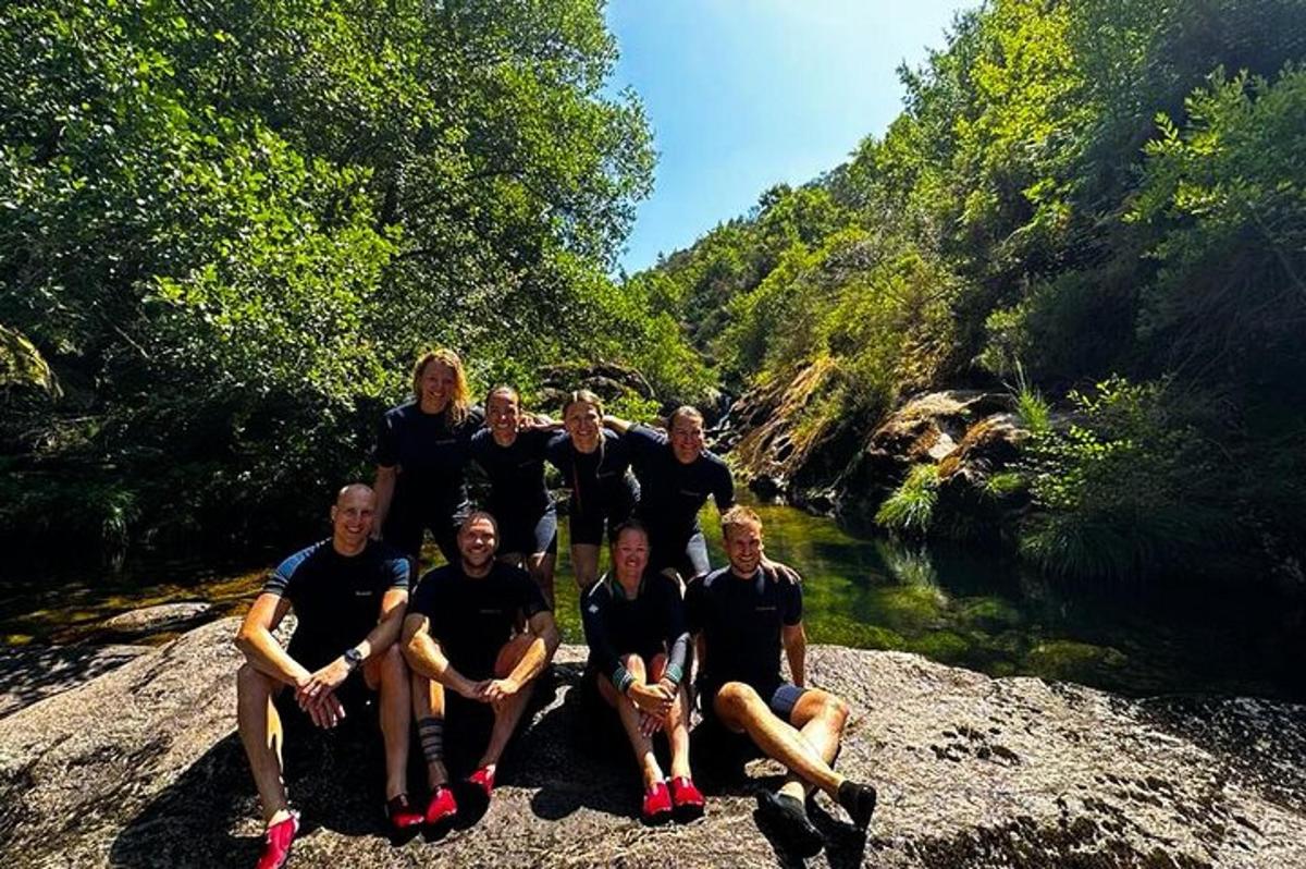 a group of people posing for a picture on a river