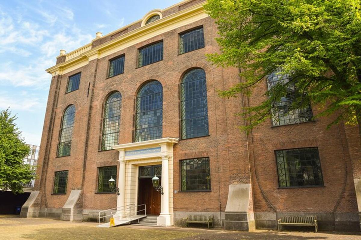 a large brick building with a staircase in front of it