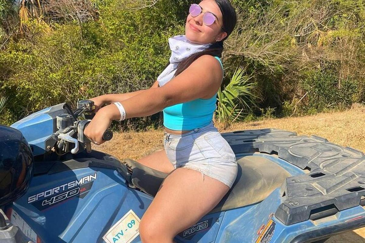 uma mulher está sentada em uma moto de terra