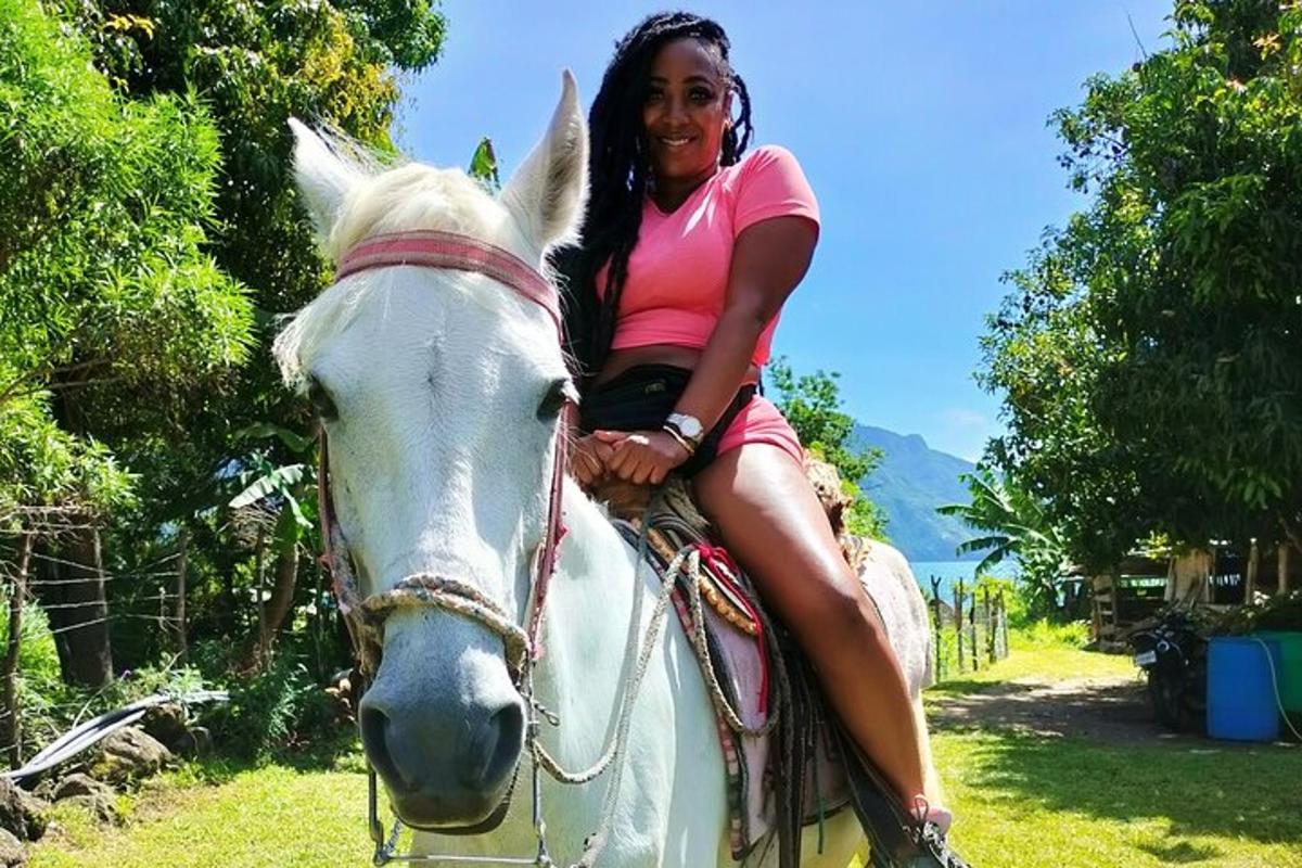 a woman sitting on top of a white horse