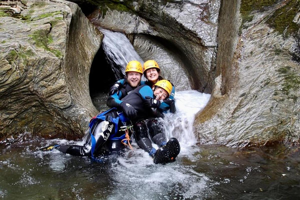a group of three people in the water in a cave