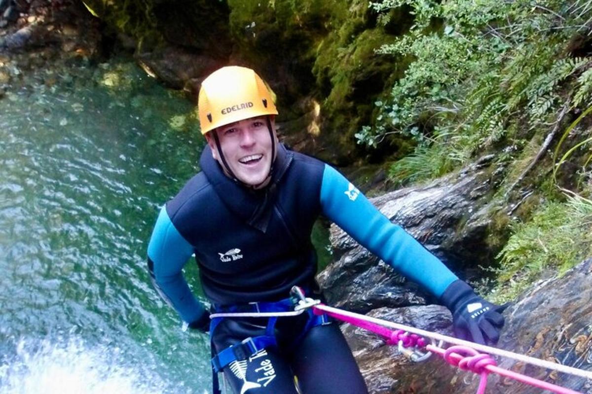 a man in a helmet on a raft in a river