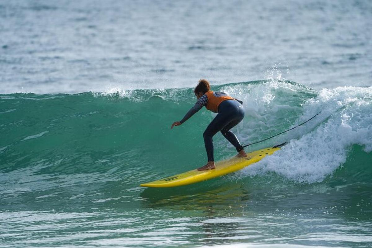 una persona cavalcant una onada sobre una taula de surf a l'oceà